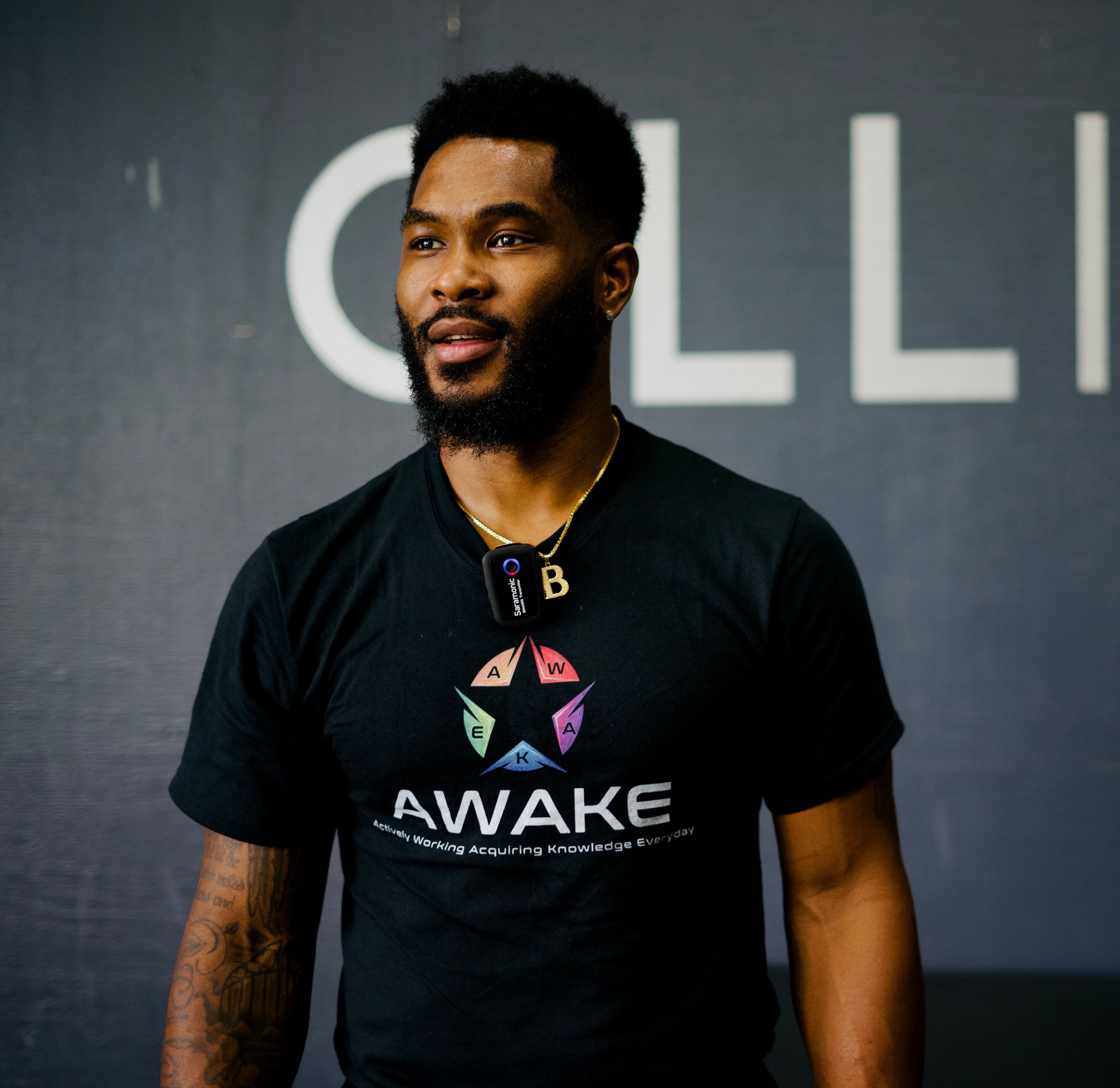 Brandon Johnson speaking, wearing an AWAKE Program shirt